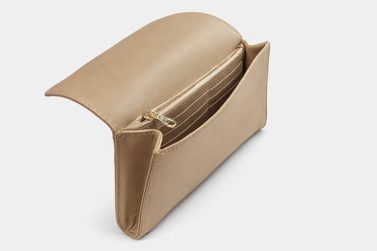 Salome foldover clutch in sand open showing gold-zip pocket and card slots interior